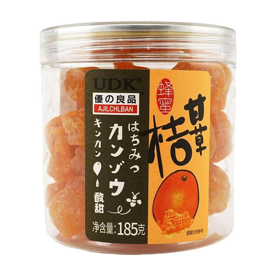 优之良品蜂蜜甘草桔，透明罐装，内含饱满的橙色果干，包装标签印有UDK品牌标识及甘草桔文字。