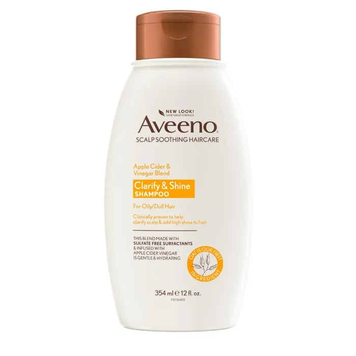 Aveeno 艾维诺苹果醋洗发水正面图，白色瓶身配棕色瓶盖，标签显示 Clarify & Shine Shampoo。