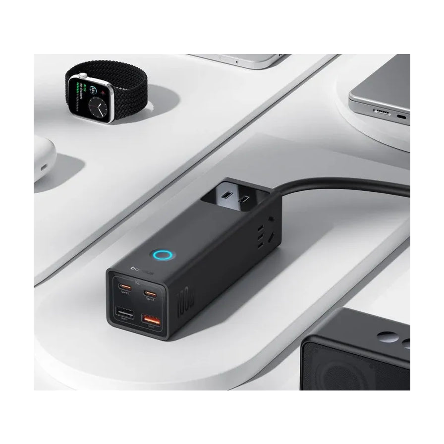 倍思桌面充电站摆放在白色办公桌上的场景图，周围有智能手表、笔记本电脑等数码设备，展示其紧凑的桌面布局效果。