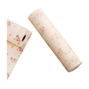 樱花图案抽屉防虫垫卷装展示，米色底粉色花朵印花，白色背景产品图。