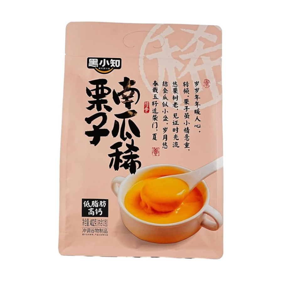 黑小知栗子南瓜糊包装袋正面，粉色背景，印有“低脂肪高钙”字样及冲泡后的橙色糊状实物图。