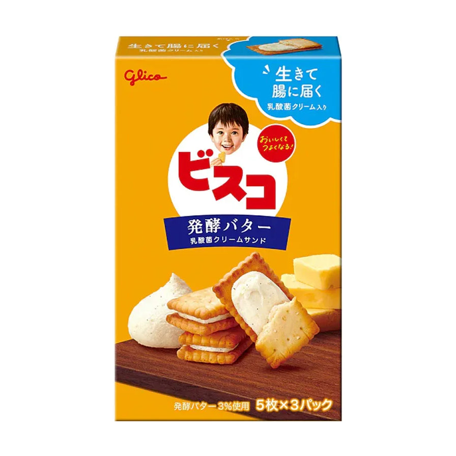 格力高乳酸夹心饼干黄油味包装正面，黄色背景，展示了酥脆饼干、乳酸夹心和黄油块，包装上有Glico品牌标识及日文说明。