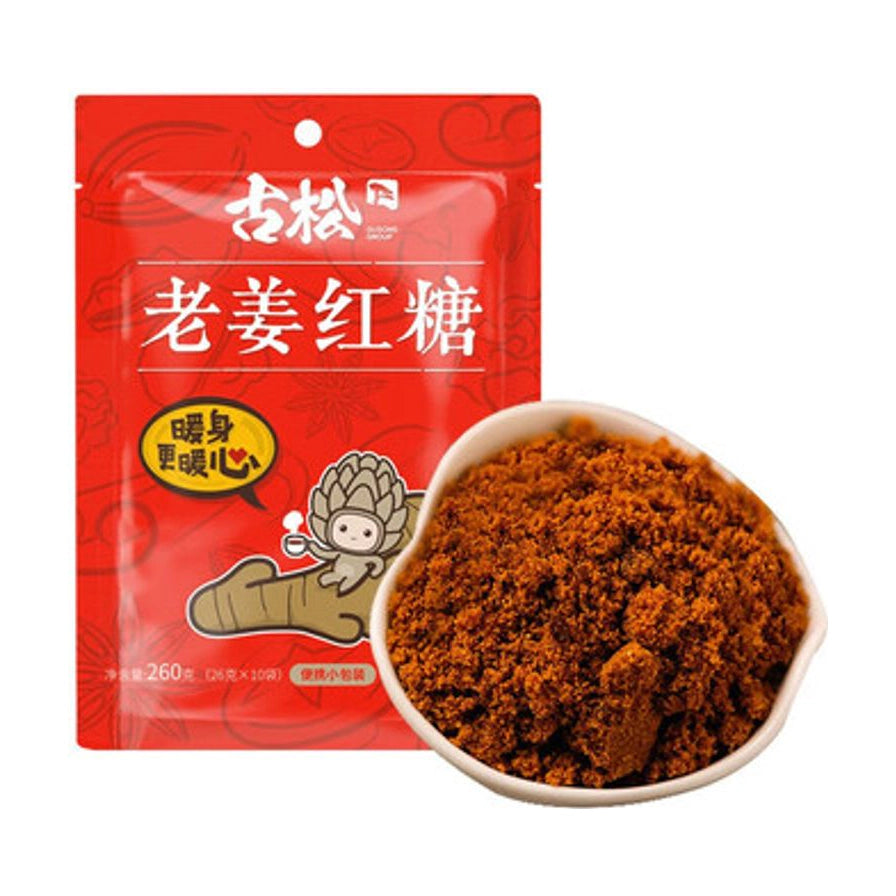 古松老姜红糖 260g 红色包装袋与碗中红糖颗粒特写，包装上印有“暖身更暖心”字样。