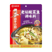 海底捞老坛酸菜鱼调味料包装正面，紫色与红色拼接设计，印有酸菜鱼成品图和筷手小厨标识。
