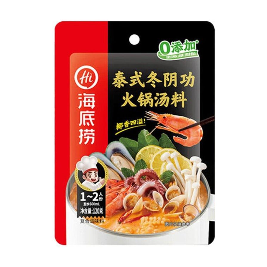 海底捞泰式冬阴功火锅汤料包装袋正面图，红黑配色设计，印有虾、鱿鱼、蘑菇等食材图案及“椰香四溢”字样。