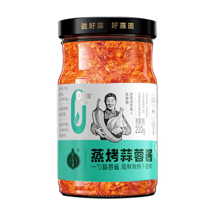 好蒜道蒸烤蒜蓉酱210g瓶装正面图，透明玻璃瓶可见金黄色蒜蓉，标签印有人物肖像及蒸烤蒜蓉酱字样。