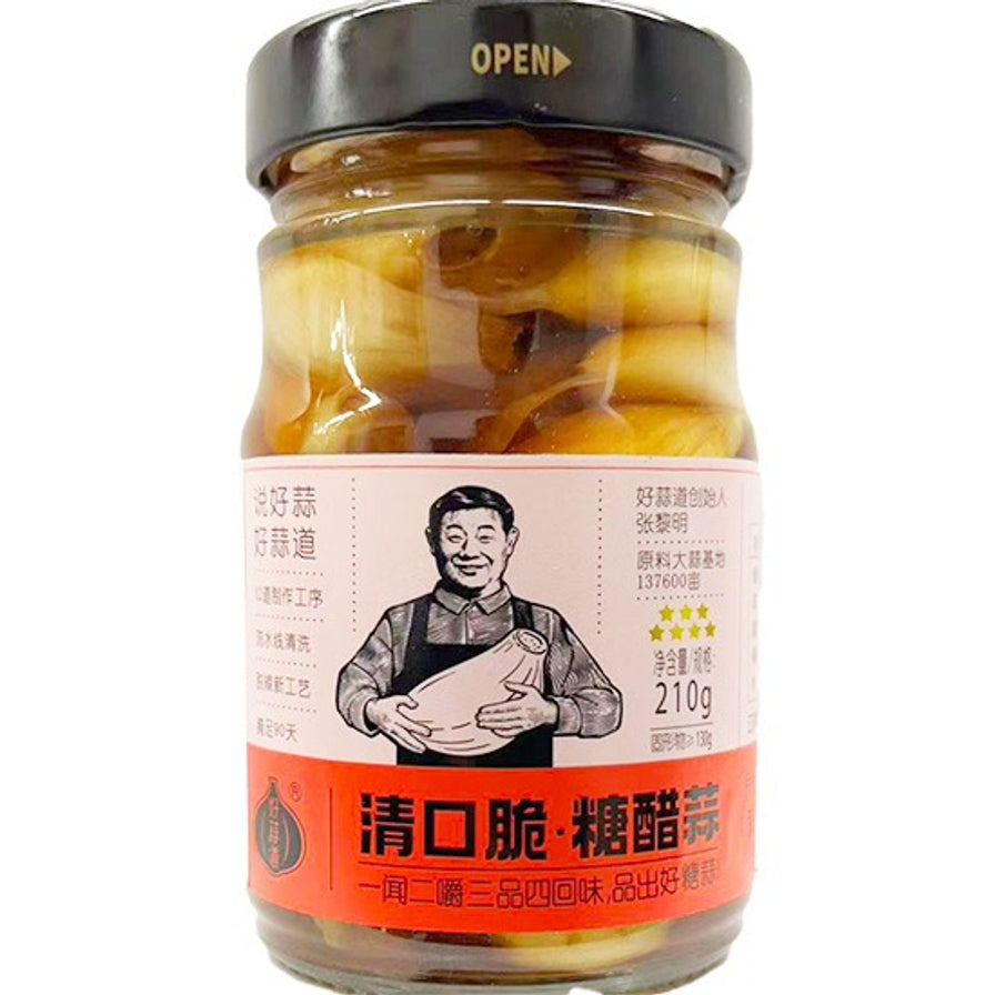 好蒜道清口脆糖醋蒜210g瓶装正面图，玻璃瓶内装有整颗糖醋蒜瓣，标签为橙白配色。