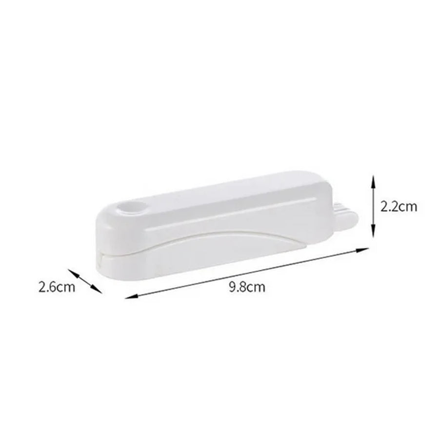 白色剥橙器的尺寸标注图，显示长度为9.8cm，宽度为2.6cm，高度为2.2cm。