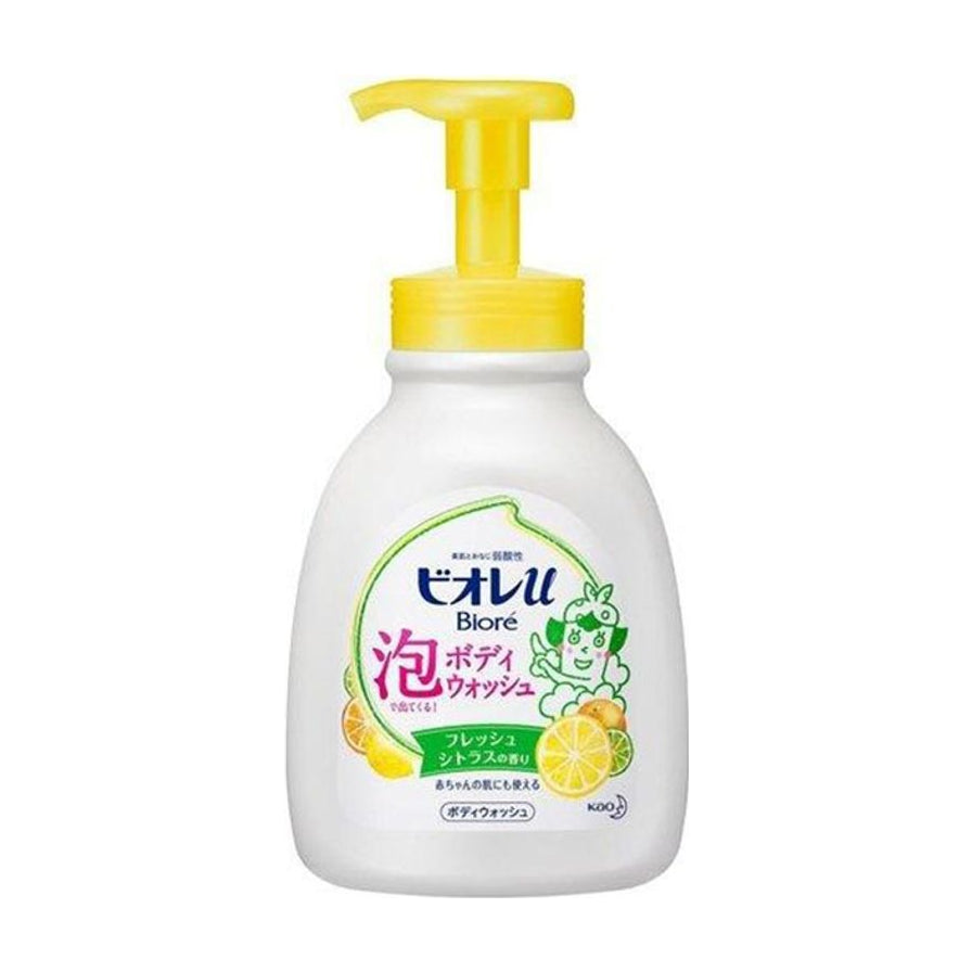 花王 Biore 儿童果香沐浴乳正面图，白色瓶身配黄色按压泵头，标签印有日文品牌名及柑橘图案。