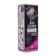 小林制药 Sumigaki 美白碳灰牙膏外包装盒正面展示，黑色与粉色设计，印有日文说明及 90g 规格标识。