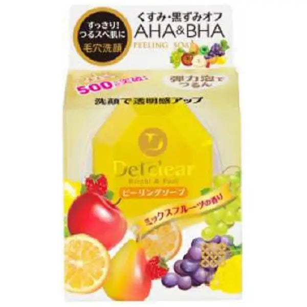 日本明色 Detclear 焕肤洁面皂包装盒正面，黄色背景印有苹果葡萄等水果图案及 AHA BHA 成分标识