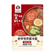 南大门明洞老爷爷荞麦冷面包装正面图，红色背景，印有老爷爷头像、韩文标识及一碗配料丰富的冷面示意图，下方标注净含量515克。