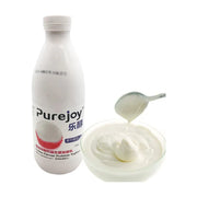 乐醇 Purejoy 荔枝味益生菌发酵乳 1kg 瓶装，旁边配有一碗质地醇厚的白色酸奶和一勺酸奶。