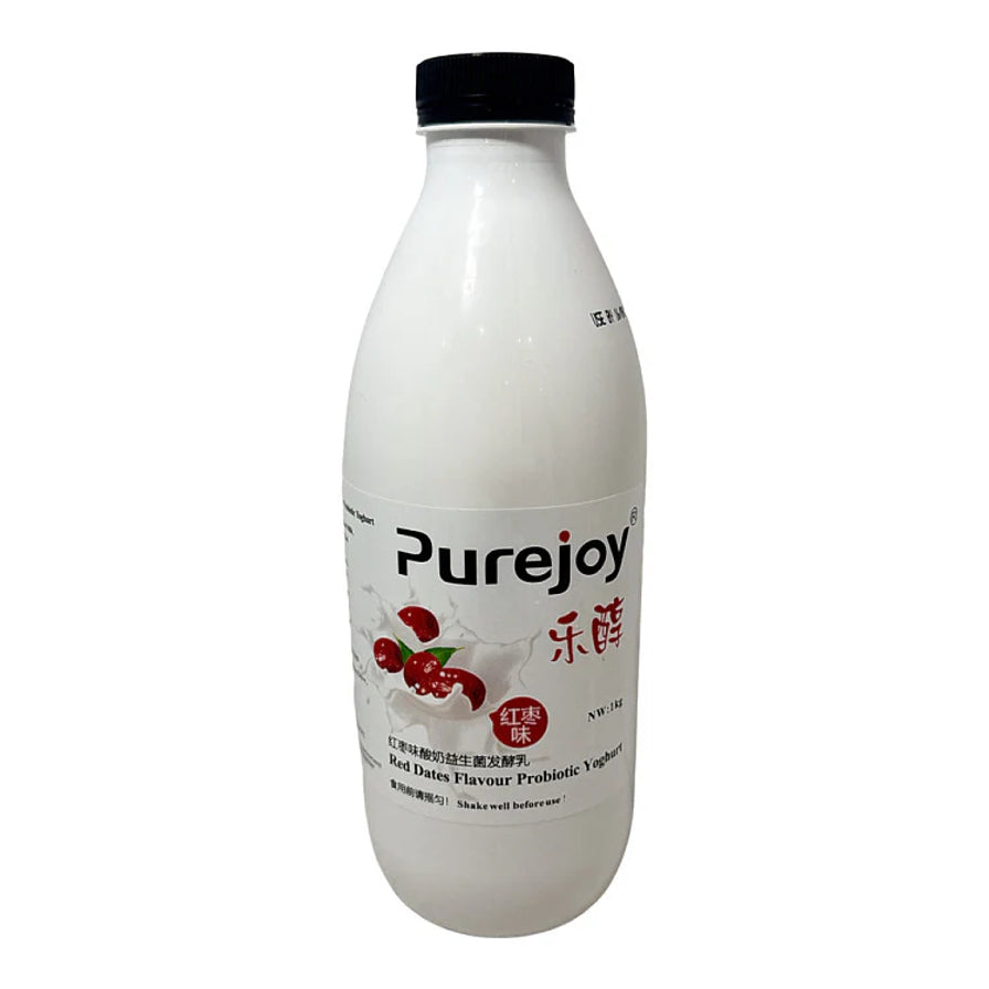 乐醇 Purejoy 红枣味益生菌发酵乳 1kg 瓶装，瓶身印有红枣与牛奶飞溅的图案，黑色瓶盖。