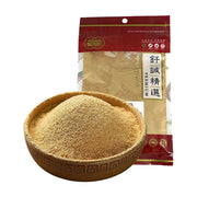 一碗细腻的黄色姜粉，背景是钎诚精选姜粉的红色密封包装袋，展示了产品的粉质状态。