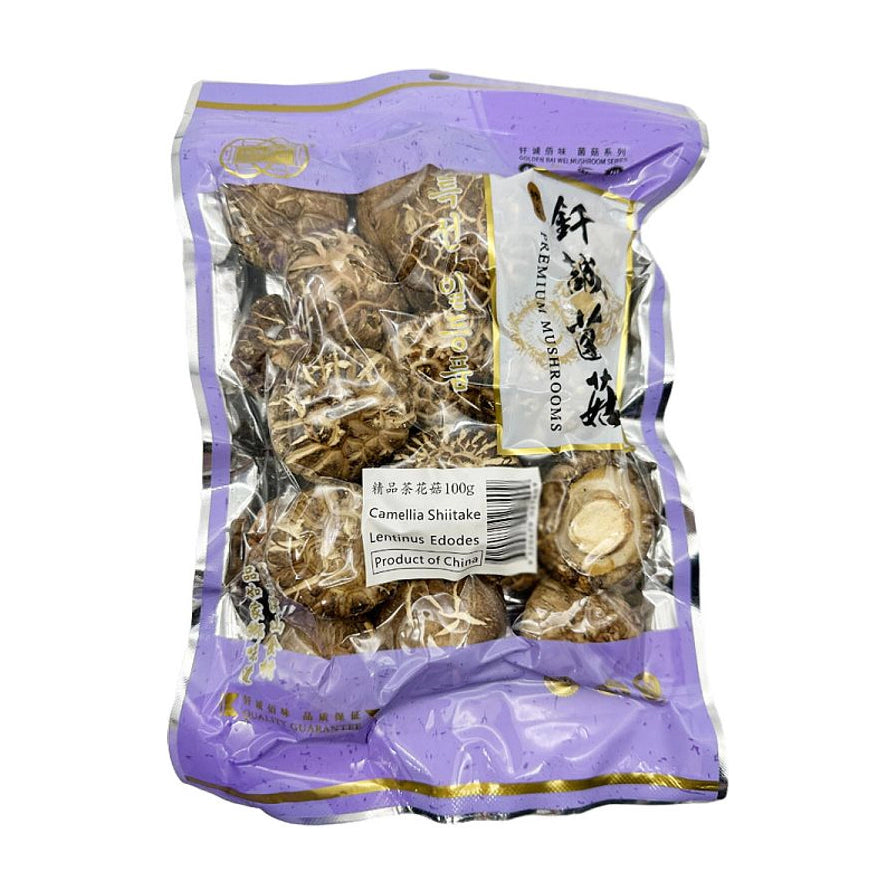 钎诚精品茶花菇100g包装正面图，紫色透明包装袋内可见肉厚花纹清晰的干香菇。