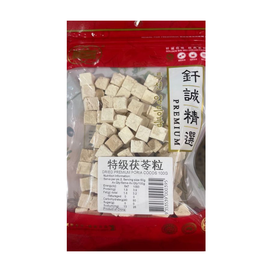 钎诚特级茯苓粒100g透明袋装正面图，可见白色方块状茯苓颗粒及营养成分表标签。