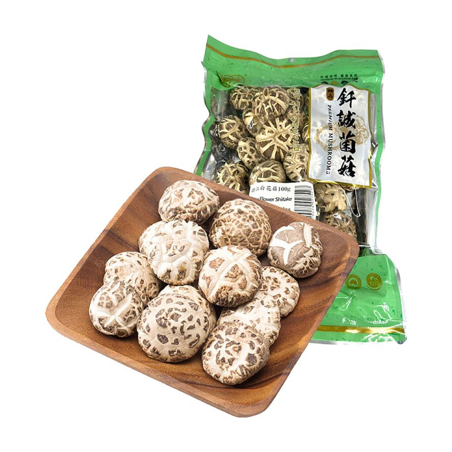 钎诚浙江白花菇100g包装袋，前方木盘盛放着多颗肉质厚实、纹路清晰的干燥白花菇。