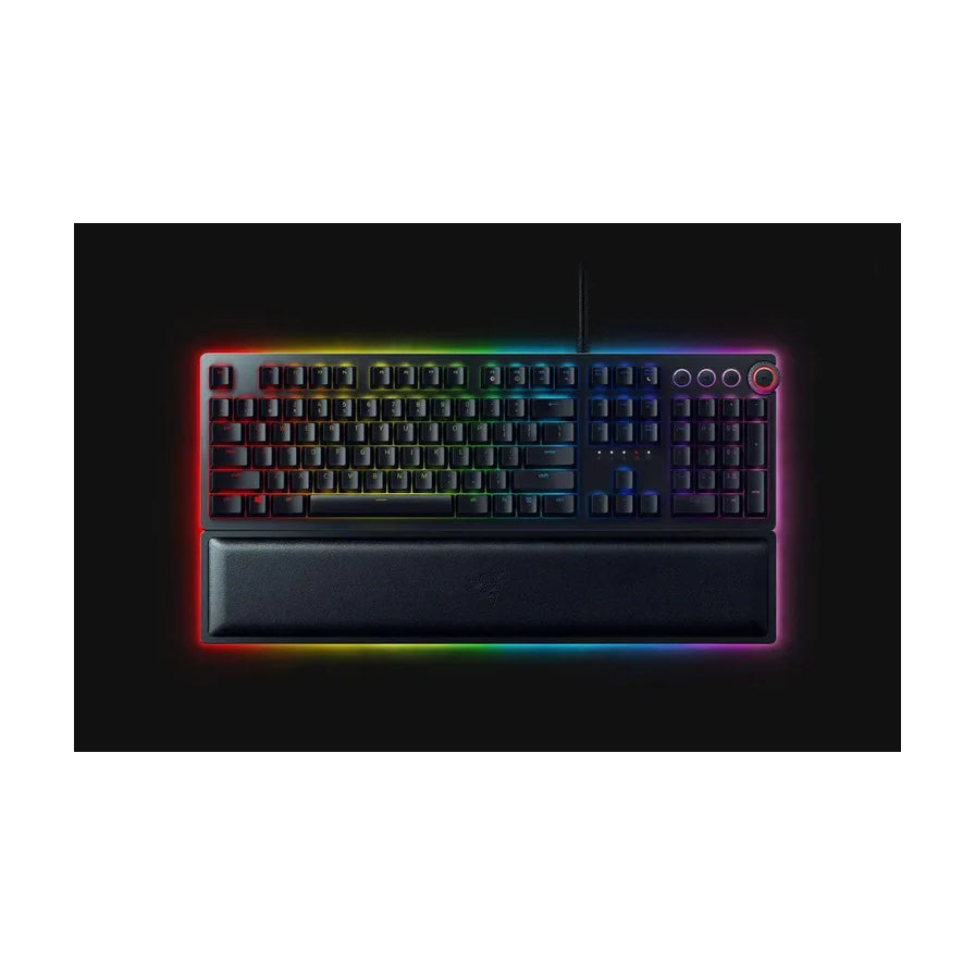 黑色背景下的 Razer Huntsman V2 机械键盘，按键周围环绕着鲜艳的 RGB 幻彩光效，配有黑色吸磁式腕托。