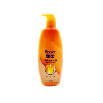 飘柔滋润去屑洗发水 500ml 橙色瓶身正面图，配备黄色按压泵头，白色背景。