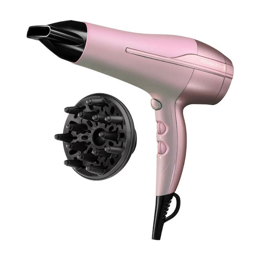 粉色 Remington 椰子油护发吹风机主机与黑色扩散风嘴配件的白底产品图。