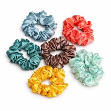 七款不同颜色的缎面发圈平铺展示，包含蓝色、红色、绿色、棕色、黄色和薄荷绿。