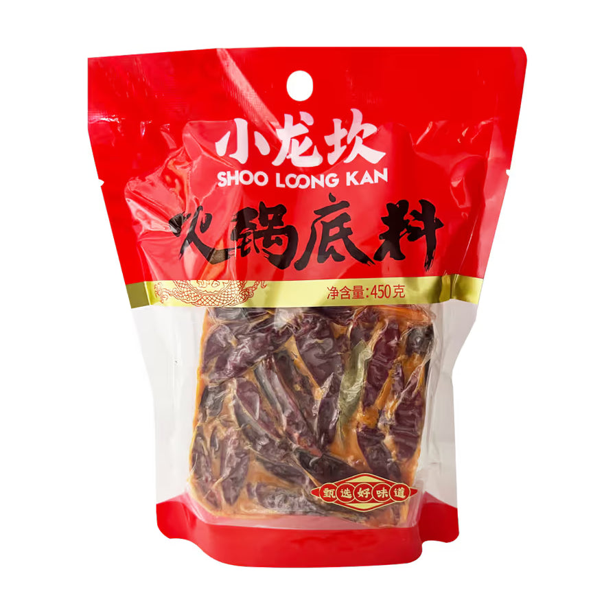 小龙坎火锅底料大块装450g包装正面图，红色包装袋，透明窗口可见内部扎实的牛油底料和干辣椒。