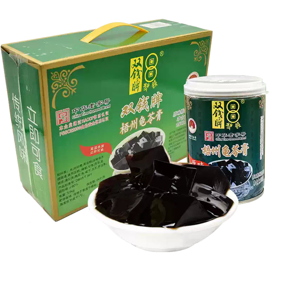 双钱牌梧州龟苓膏10瓶礼盒装，包含绿色手提外箱、单罐产品及一碗切块好的龟苓膏甜品。