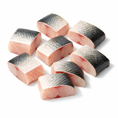白色背景下切块的生鱼中段原料，俯拍视角展示食材新鲜度。