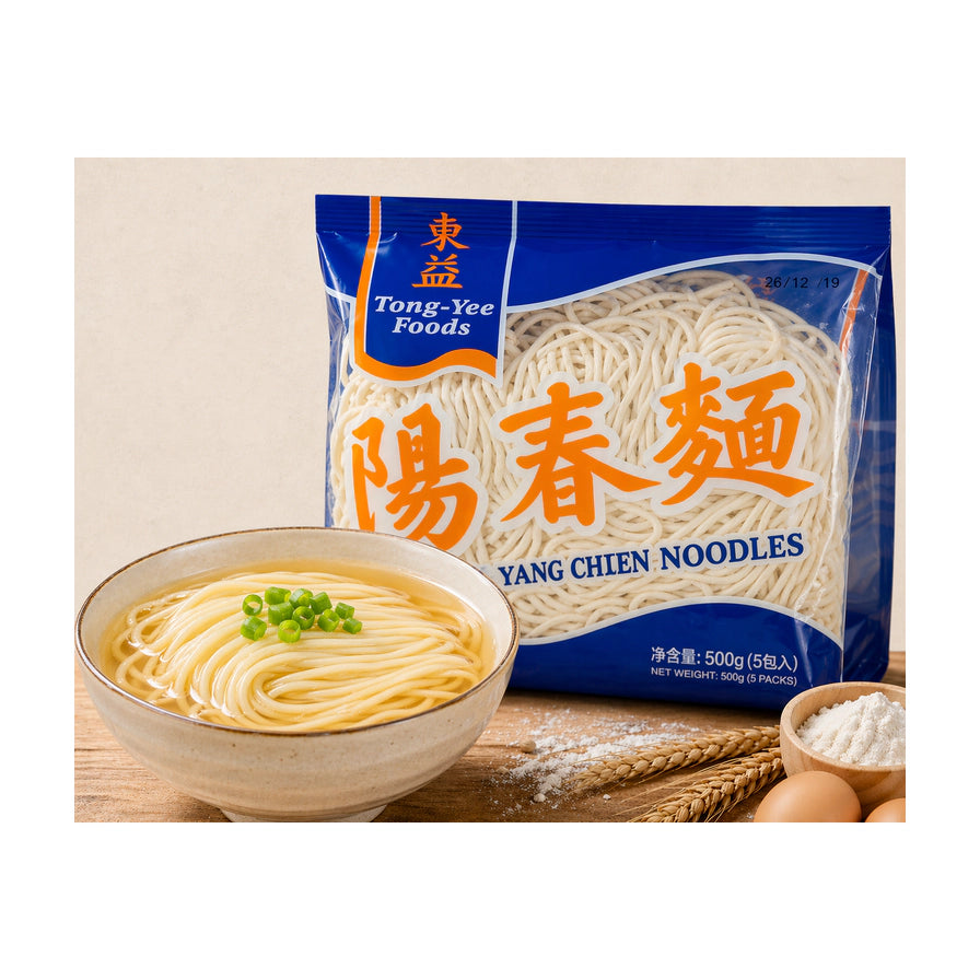 东益阳春面包装袋，旁边摆放着一碗煮好的阳春面，点缀有葱花，背景配有面粉、鸡蛋和麦穗。
