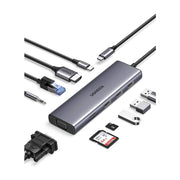 绿联九合一扩展坞，周围环绕着HDMI、USB、网口、VGA、音频线及SD卡等多种连接线材和存储介质，展示其强大的接口扩展能力。