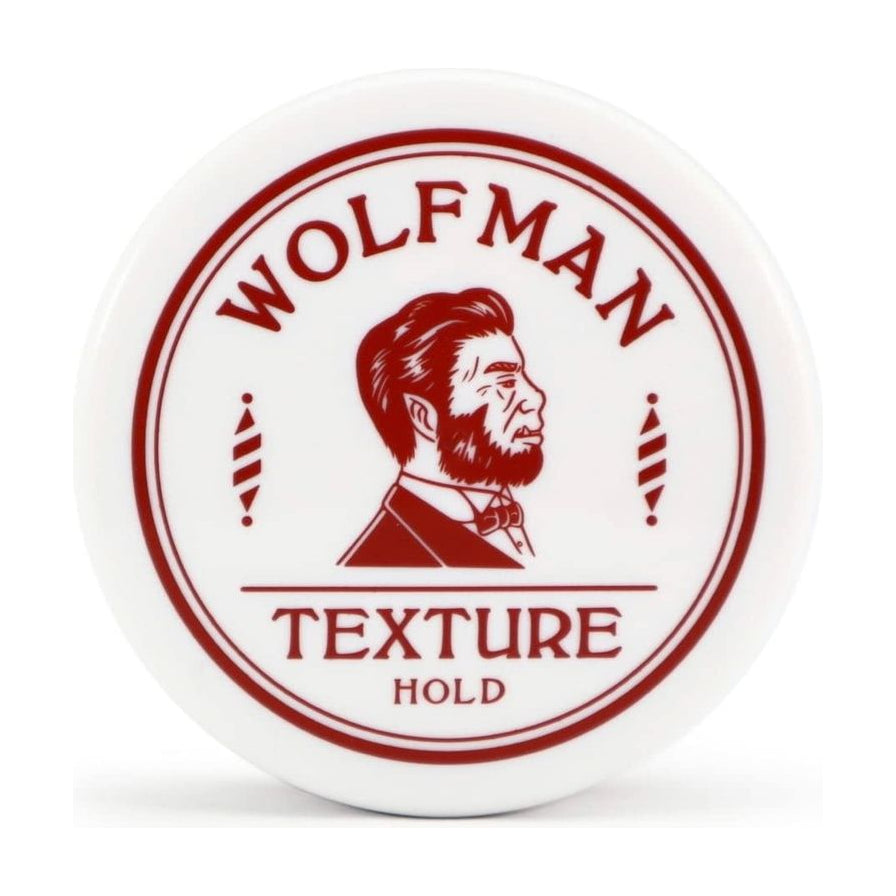 Wolfman Texture Hold 男士发油白色圆形罐装正面特写，红色品牌 Logo 与胡须绅士图案清晰可见。