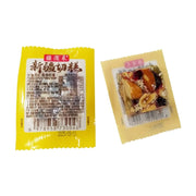 疆滋来新疆切糕独立小包装展示，左侧为黄色包装袋背面印有营养成分表及条形码，右侧为透明包装正面可见核桃仁、葡萄干等丰富果料。