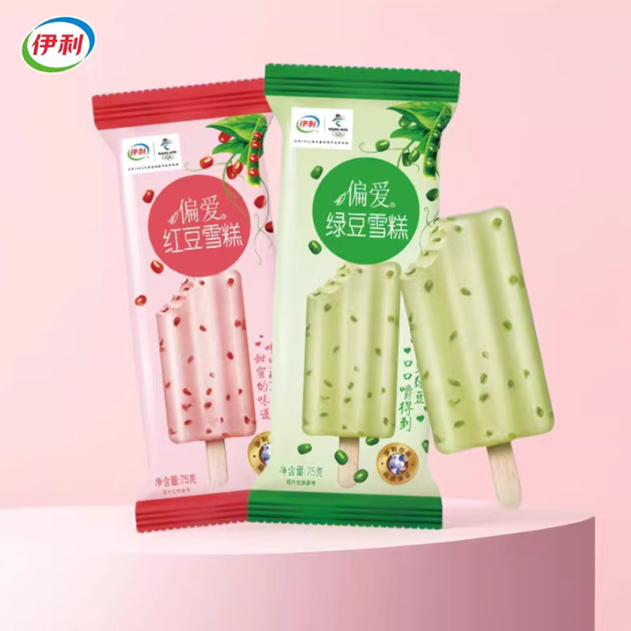 伊利偏爱系列红豆与绿豆雪糕包装及拆封后的雪糕展示，粉色背景，雪糕质地细腻并带有豆类颗粒。
