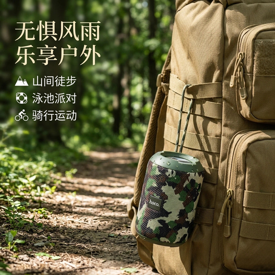 迷彩款 hoco. 浩酷 HC1 蓝牙音箱挂在户外运动背包上的实景图，配有“无惧风雨 乐享户外”中文标题。