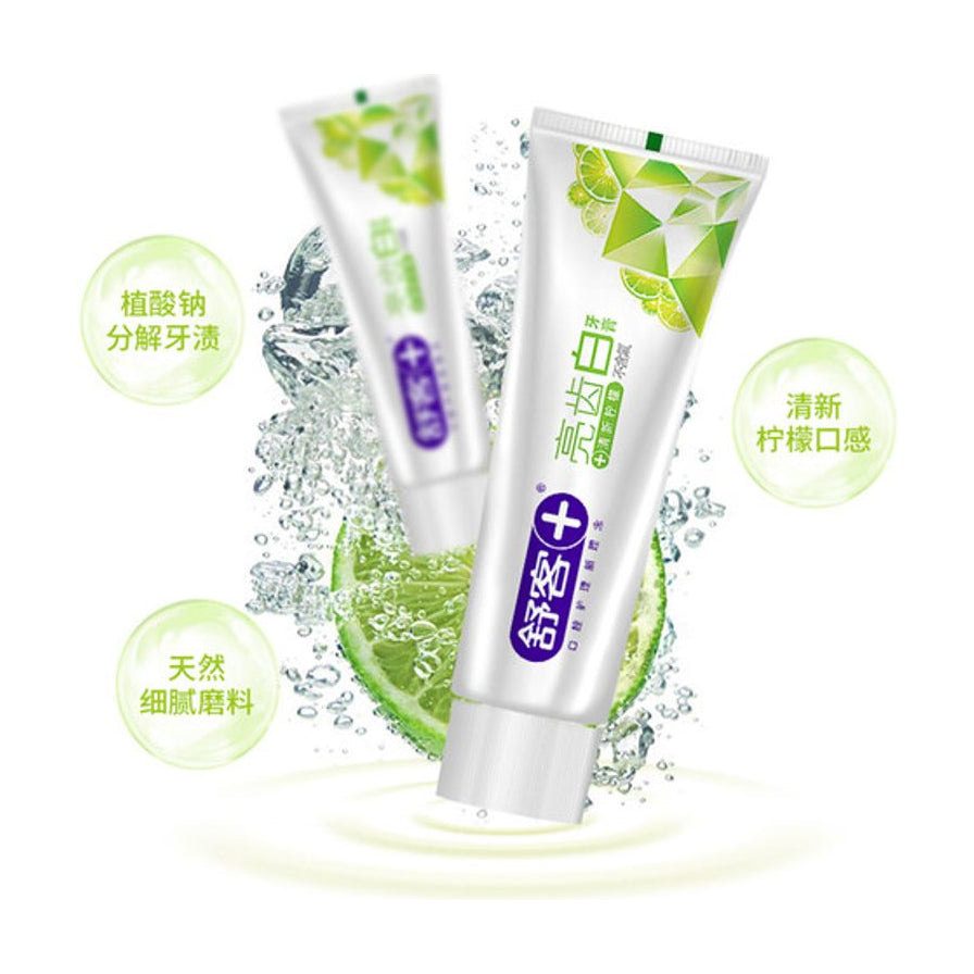 舒客亮齿白牙膏产品展示，背景伴有动感水花与青柠檬，图中带有植酸钠分解牙渍、天然细腻磨料、清新柠檬口感的文字说明。