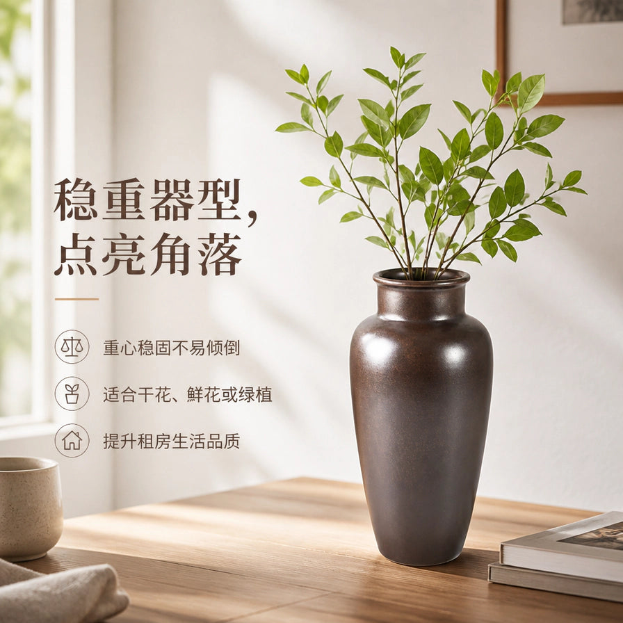 墨蓝制造柳瓶花瓶摆放在木质桌面上的场景图，插有绿色植物枝条，展现简约高级家居氛围。