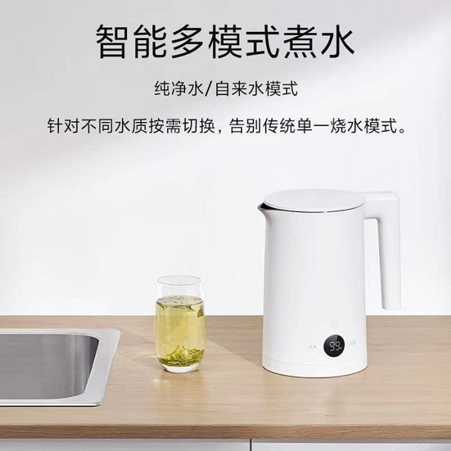 小米米家恒温电水壶P1放置在厨房台面上，旁边有一杯绿茶，上方文字介绍智能多模式煮水功能。