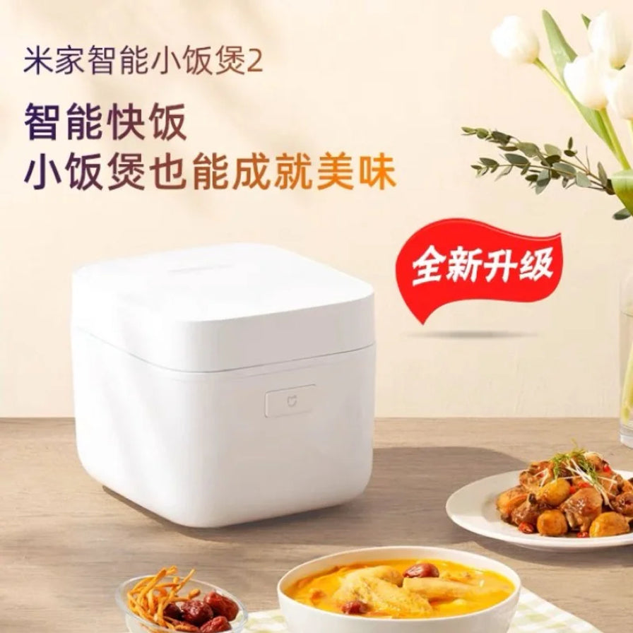 小米米家智能小饭煲2在餐桌上的场景图，带有“全新升级”和“智能快饭”宣传文字，背景有鲜花装饰。